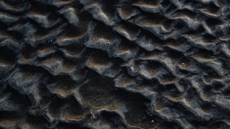 Rippled sand creates a textured pattern.
